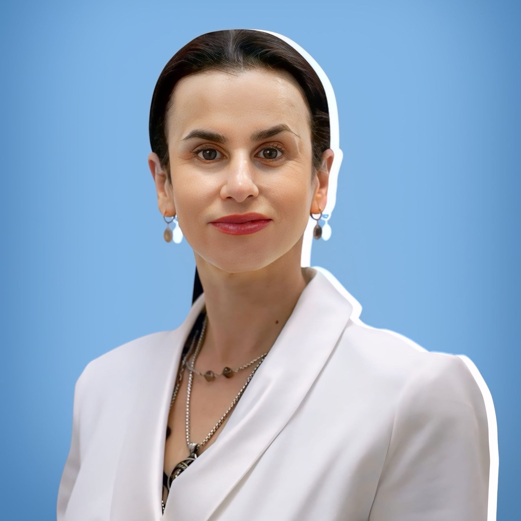 Woman wearing a white blazer against a blue background